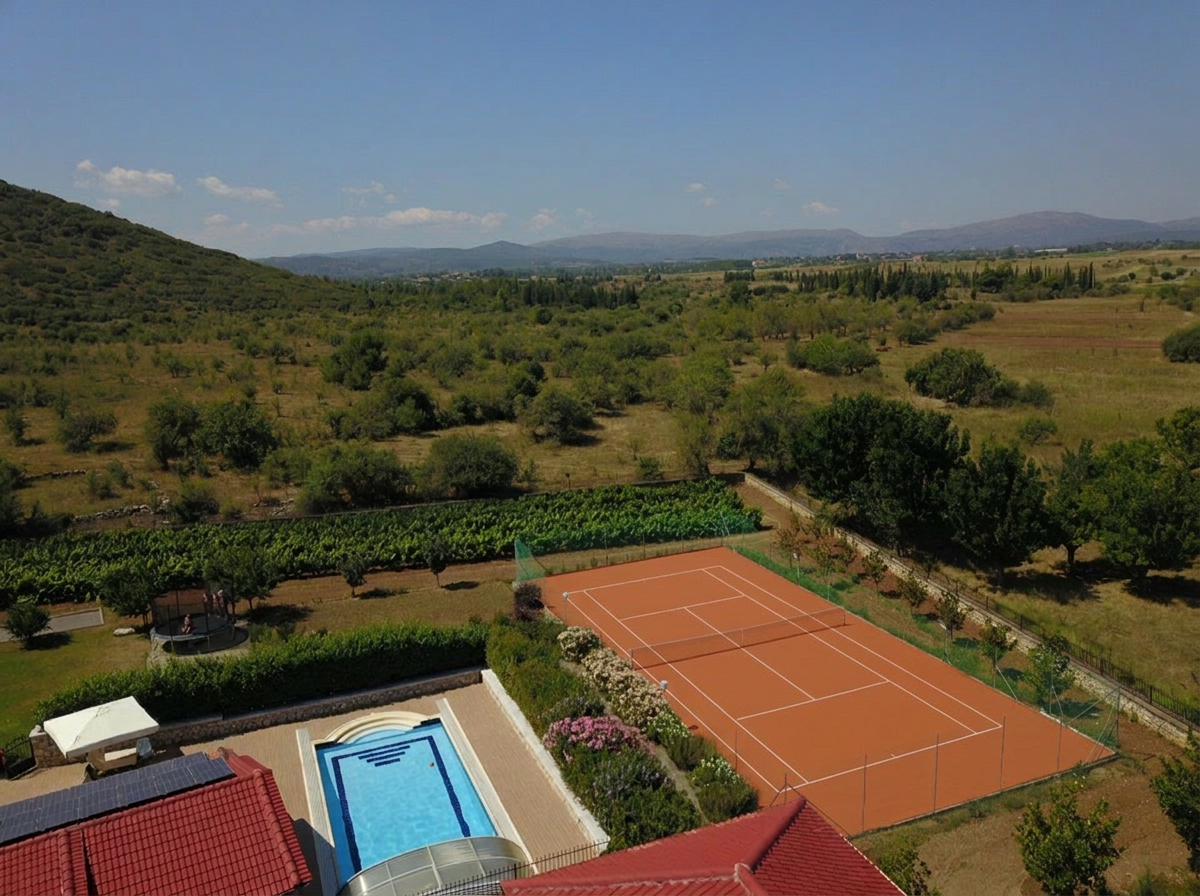 Tennis court, vineyard and valley view Aerial view from Villa Arcadia over the private tennis court, vineyard and mountain valley