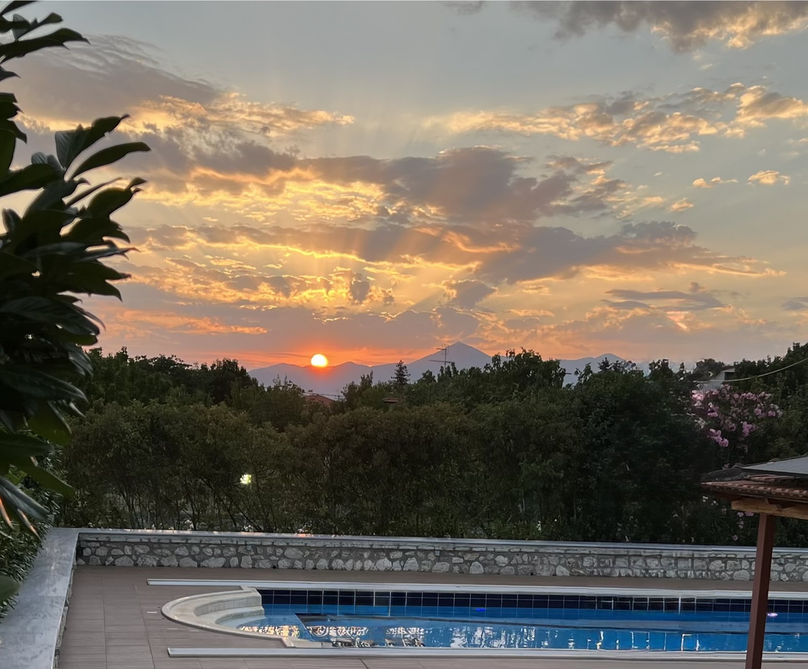 Sunset over the pool and mountains Sunset over the mountains behind the heated pool at Villa Arcadia