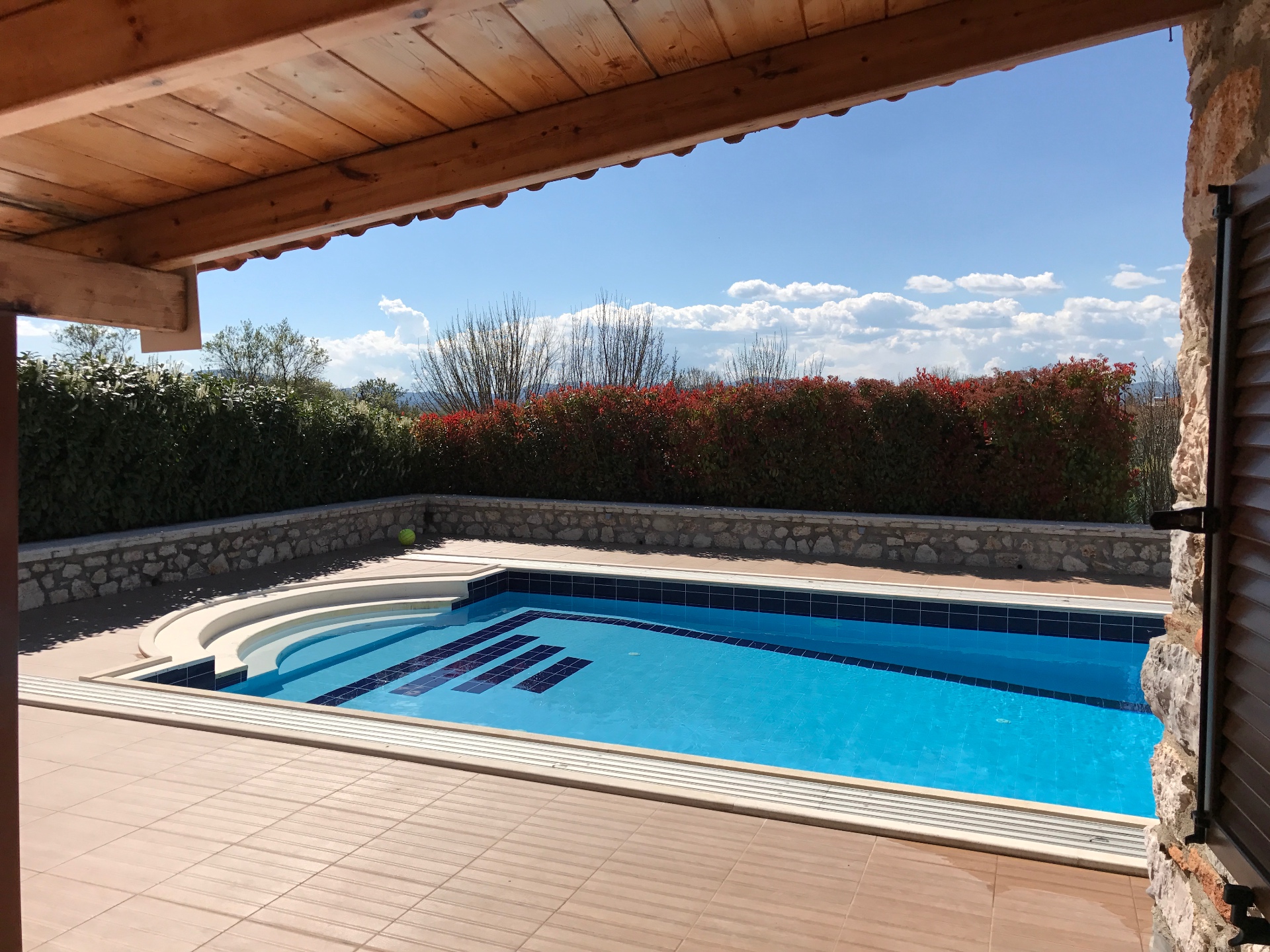 Pool from the covered terrace Villa Arcadia pool seen from the covered stone terrace with mountain views